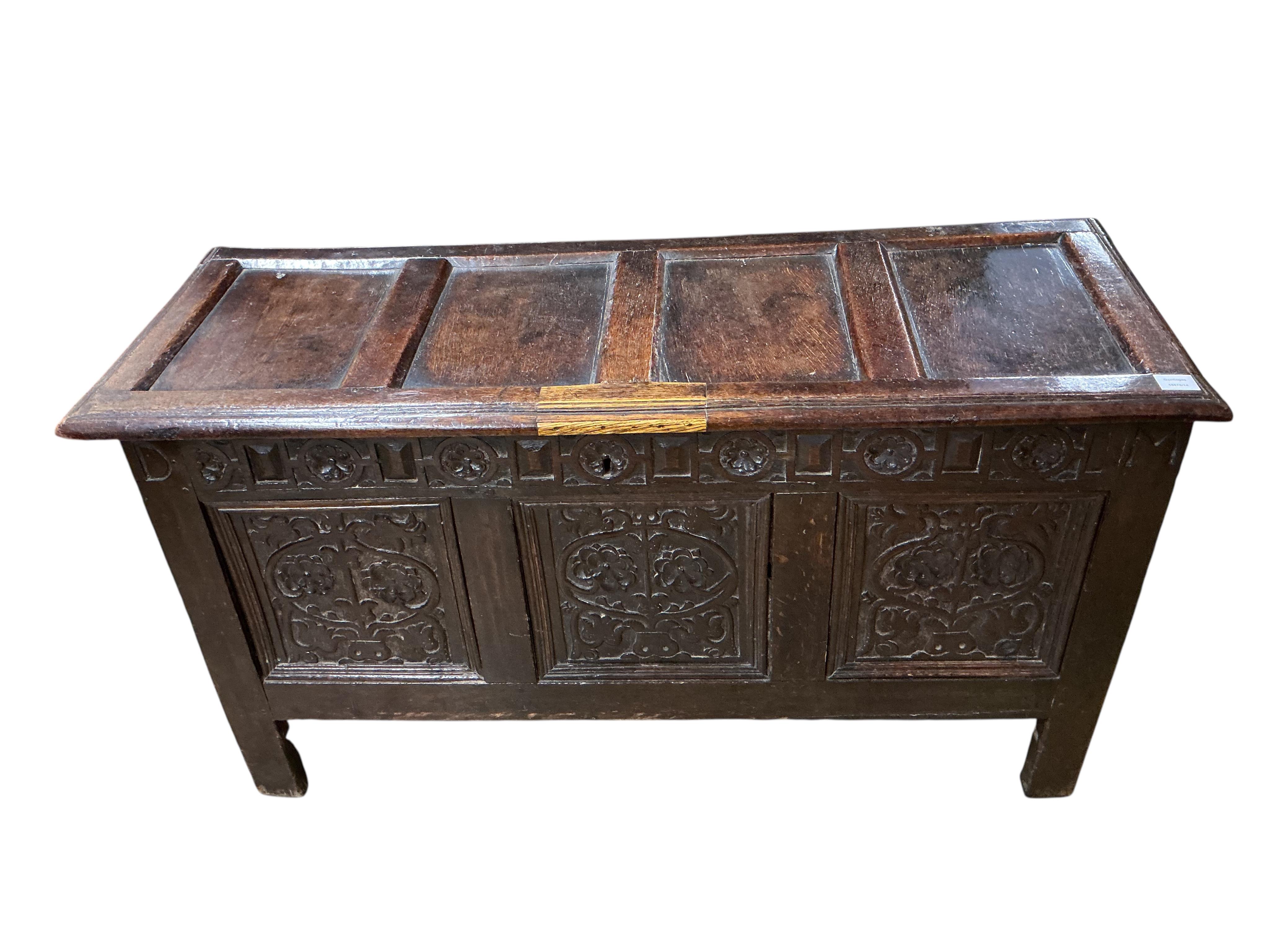 A late 17th century carved oak triple panelled coffer, the top rail monogrammed D.M, width 128cm, depth 48cm, height 68cm